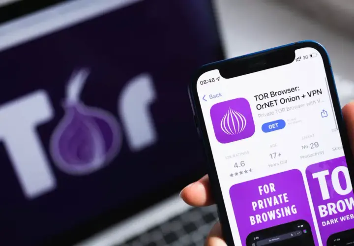 Smartfon z aplikacją TOR Browser, obok laptop z logo sieci Tor. Prywatność w sieci.