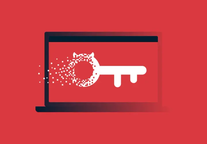 Laptop z kluczem, którego część rozpada się na piksele. To wizualizacja tego, czym jest malware.