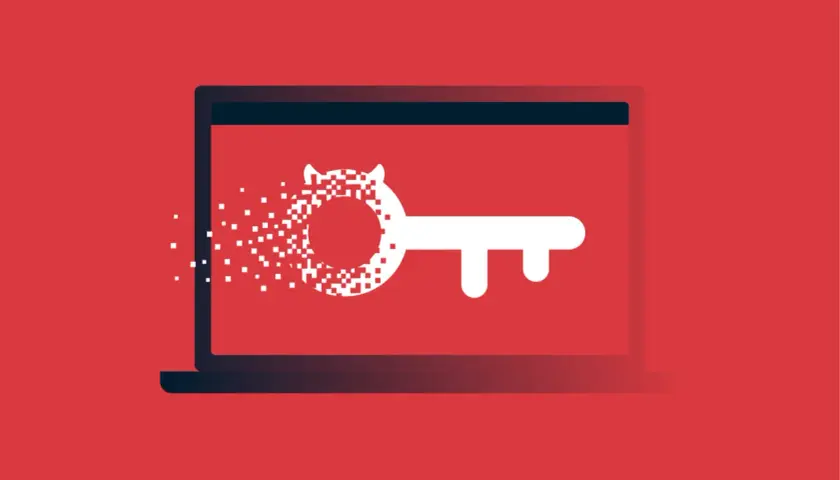 Laptop z kluczem, którego część rozpada się na piksele. To wizualizacja tego, czym jest malware.