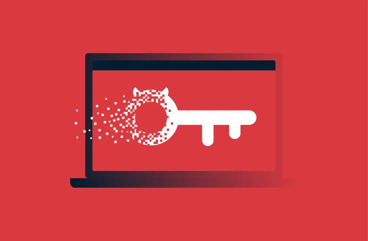Laptop z kluczem, którego część rozpada się na piksele. To wizualizacja tego, czym jest malware.