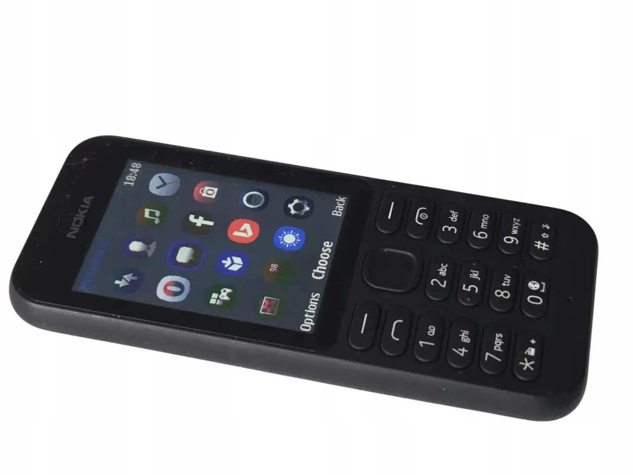 Czarny telefon Nokia z ikonami aplikacji, przypominający o dawnych grach na telefon.
